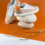 Two tan shoes posed on stones
